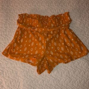 Orange Beachy Shorts with White Accents.